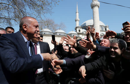 Turkish President Tayyip Erdogan is greeted by his supporters as he leaves a mosque after the Friday prayers in Istanbul, Turkey April 5, 2019. Cem Oksuz/Presidential Press Office/Handout via REUTERS