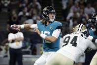 Jacksonville Jaguars quarterback Trevor Lawrence (16) drops back to pass under pressure from New Orleans Saints defensive end Cameron Jordan (94) in the first half of an NFL preseason football game in New Orleans, Monday, Aug. 23, 2021. (AP Photo/Derick Hingle)