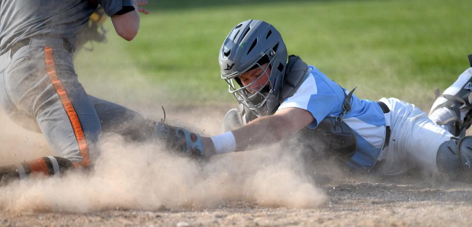 Alliance catcher Ryan Bruni tags out Marlinton's Dylan Heatherington stealing home in the fifth inning, Friday, March 5, 2023.