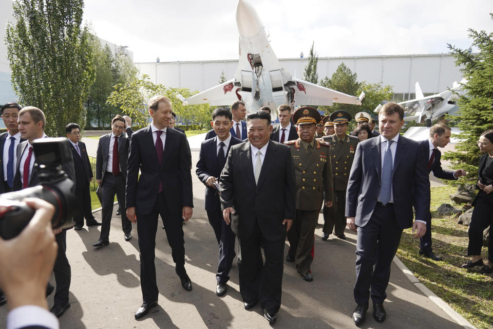 In this photo released by the Khabarovsky Krai region government, North Korean leader Kim Jong Un, center, walks accompanied by Deputy Prime Minister and Minister of Trade and Industry Denis Manturov, center left, while visiting a Russian aircraft plant that builds fighter jets in Komsomolsk-on-Amur, about 6,200 kilometers (3,900 miles) east of Moscow, Russia, Friday, Sept. 15, 2023. (Khabarovsky Krai region government via AP)