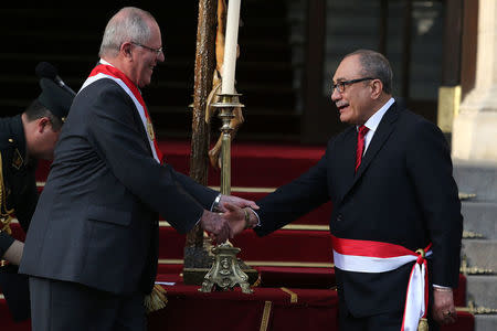 Peru's President Pedro Pablo Kuczynski and new Minister of Education Idel Vexler shake hands during his swearing-in ceremony at the government palace in Lima, Peru September 17, 2017. REUTERS/Guadalupe Pardo