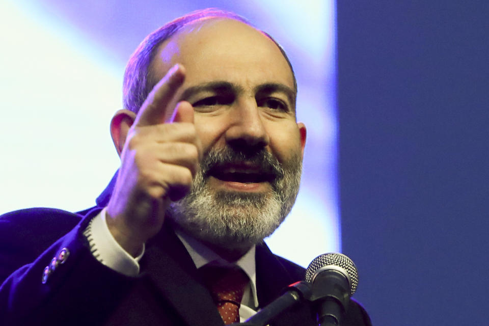 Armenian Prime Minister Nikol Pashinyan gestures while addressing his supporters during a rally in his support in the center of Yerevan, Armenia, Monday, March 1, 2021. Amid escalating political tensions in Armenia, supporters of the country's embattled prime minister and the opposition are staging massive rival rallies in the capital of Yerevan. Prime Minister Nikol Pashinyan has faced opposition demands to resign since he signed a peace deal in November that ended six weeks of intense fighting with Azerbaijan over the Nagorno-Karabakh region. (Hayk Baghdasaryan/PHOTOLURE via AP)