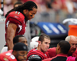 Cardinals WR Larry Fitzgerald checks on Max Hall after a big first-half hit on the quarterback