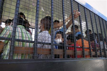 Suspected Uighurs are transported back to a detention facility in the town of Songkhla in southern Thailand after visiting women and children at a separate shelter March 26, 2014. Picture taken March 26, 2014. REUTERS/Andrew RC Marshall