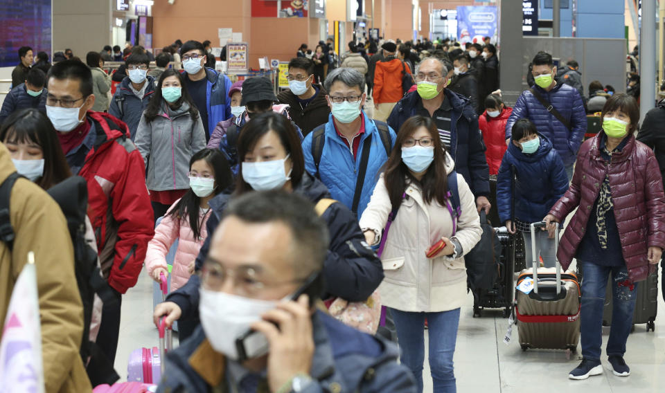 Passengers from Taiwan, wearing masks arrive at Kansai Airport in Osaka Prefecture on January 27, 2020.