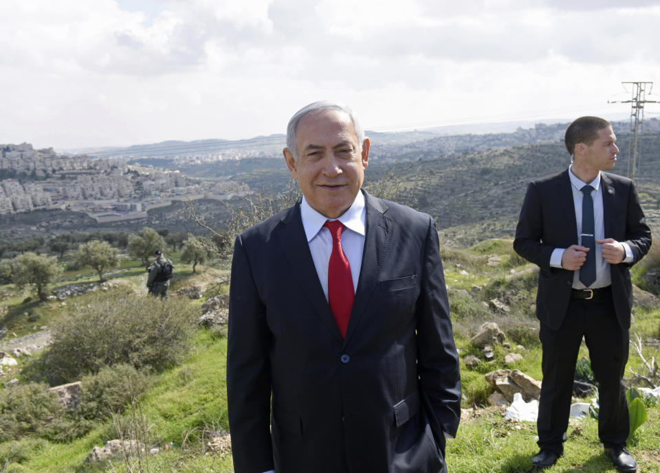 Israeli Prime Minister Benjamin Netanyahu stands at an overview of the West Bank Israeli settlement of Har Homa where he announced a new neighborhood is to be built, Thursday, Feb. 20, 2020. (Debbie Hill/Pool via AP)