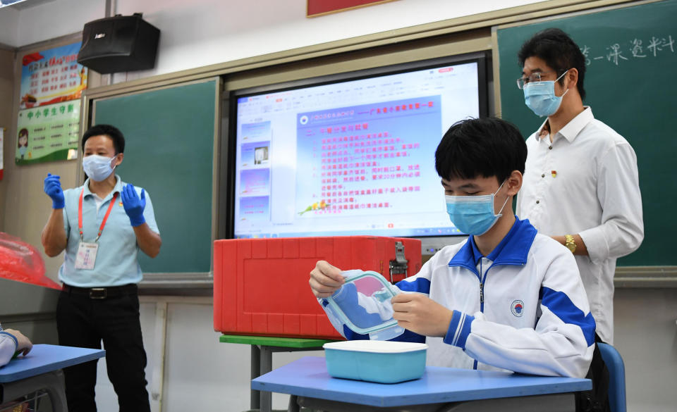 GUANGZHOU, April 27, 2020 -- A student demonstrates dining precautions in class at Guangzhou Huadi Middle School in Liwan District of Guangzhou, south China's Guangdong Province, April 27, 2020. Students in graduating classes of Guangzhou's junior and senior high schools returned to school on Monday as the novel coronavirus epidemic continued to ebb away across the country. (Photo by Deng Hua/Xinhua via Getty) (Xinhua/Deng Hua via Getty Images)