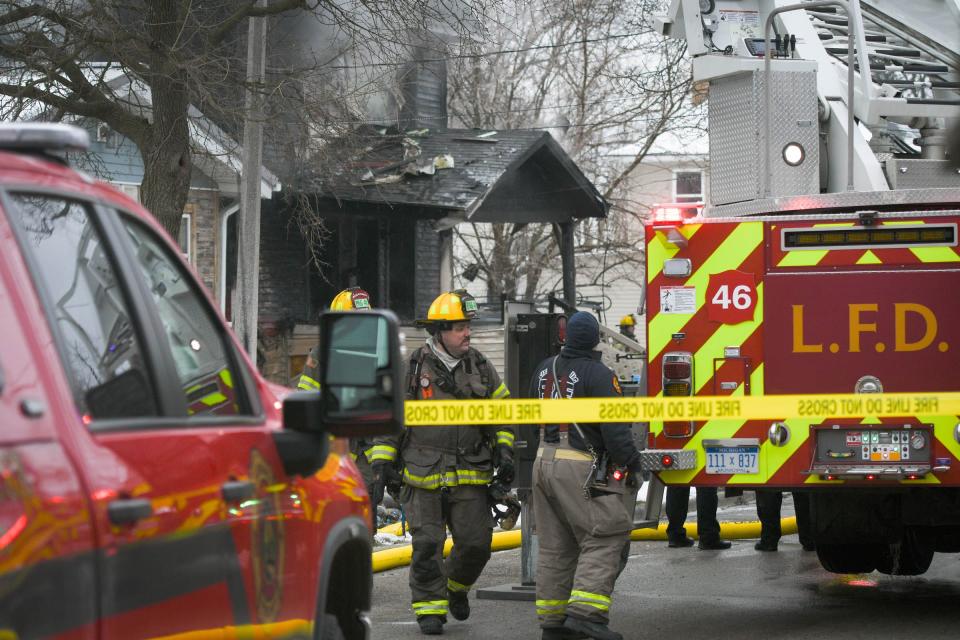 Firefighters with the Lansing Fire Department work at the scene at a fatal fire in the 500 block of Rulison in Lansing.