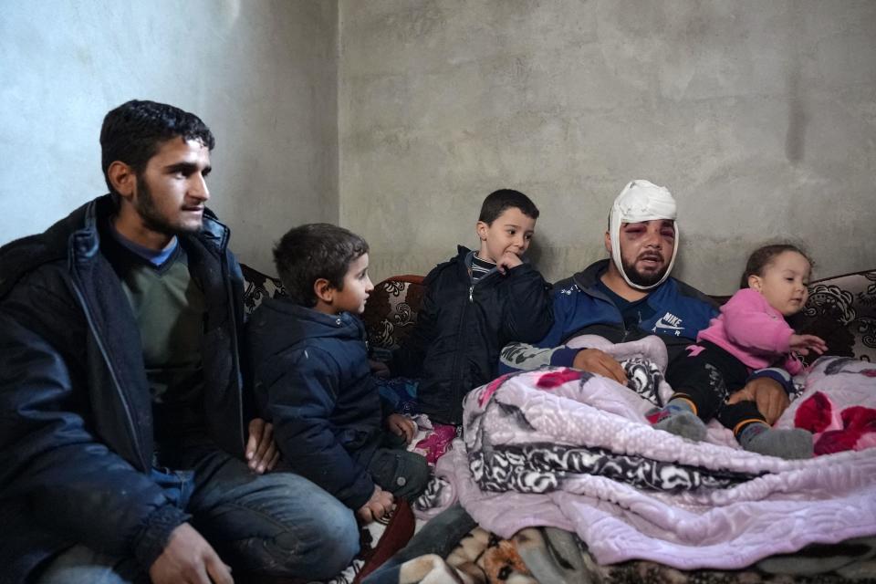 Ghayath Zarzour (2-R), who was injured in a deadly earthquake sits among family members in a makeshift shelter in the camp of Deir Ballut for internally displaced people, in the Afrin region of Syria's rebel-held northern Aleppo province, on February 8, 2022, after being left homeless. / Credit: RAMI AL SAYED/AFP/Getty