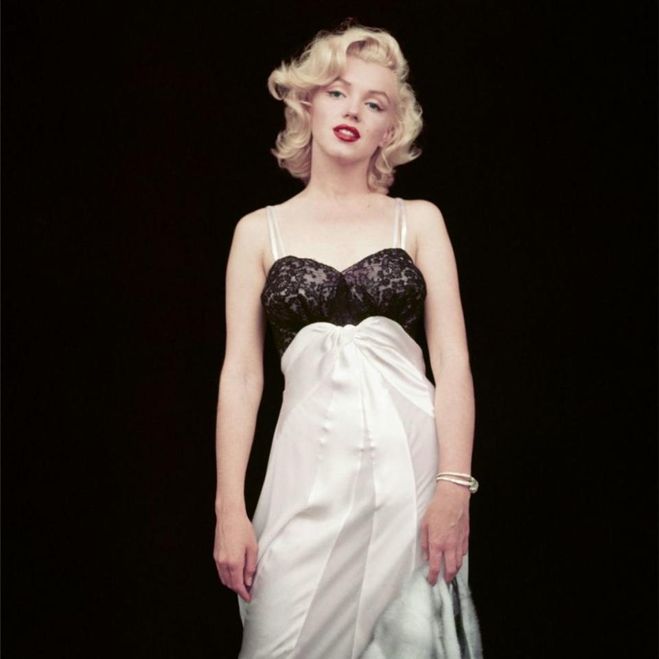 <p>In a negligee adorned with fur and a diamond bracelet, September 1953.</p><p><br></p>