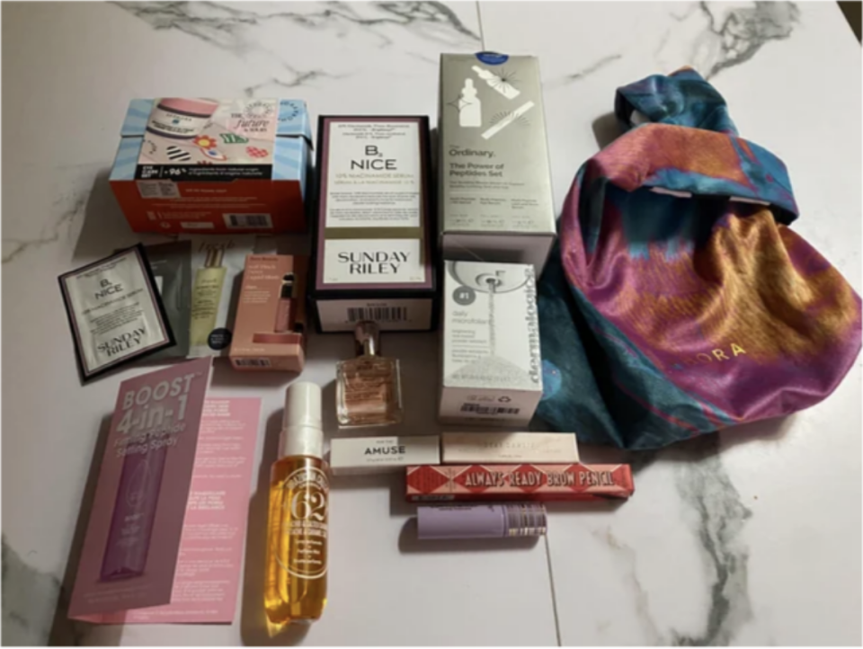 a sephora skincare haul; various lotions and oils are laid out in their packages on a marble counter