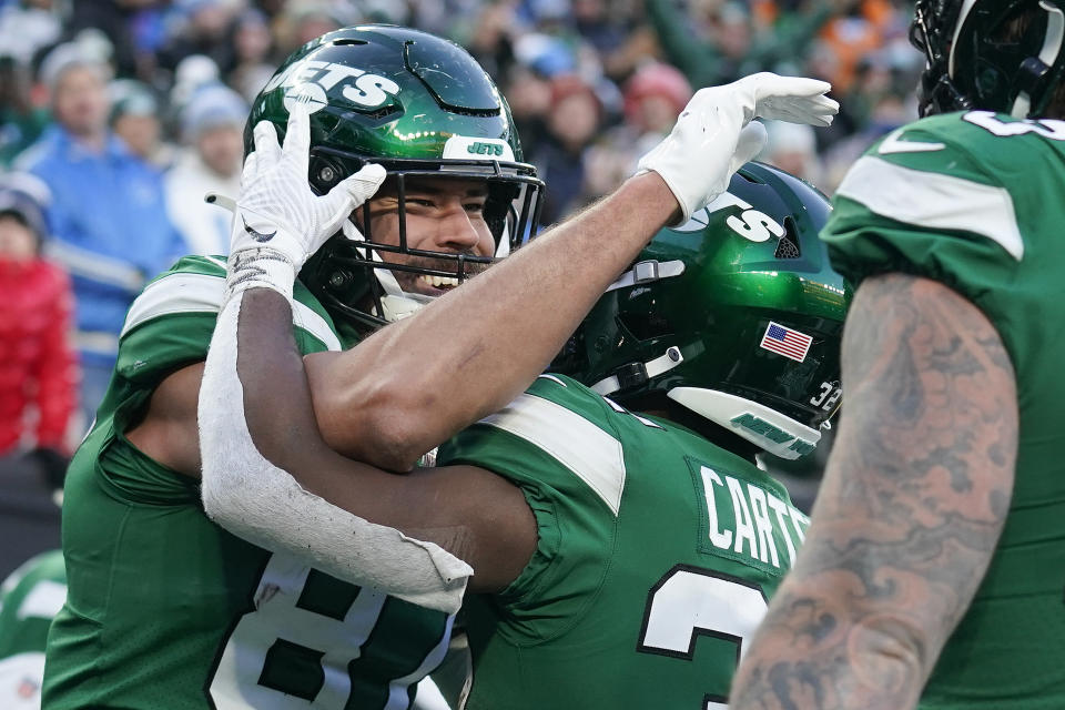 New York Jets tight end C.J. Uzomah (87) celebrates his second touchdown of the game against the Detroit Lions during the fourth quarter of an NFL football game, Sunday, Dec. 18, 2022, in East Rutherford, N.J. (AP Photo/Seth Wenig)