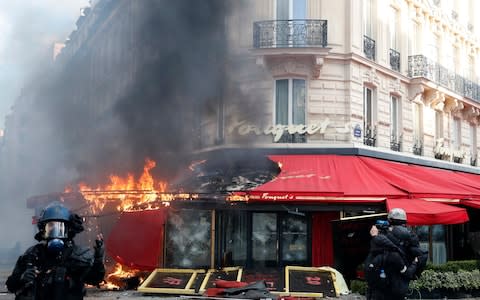 Paris famed restaurant Fouquet's burns on the Champs Elysees avenue during a yellow vests demonstration Saturday, March 16, 2019 in Paris.