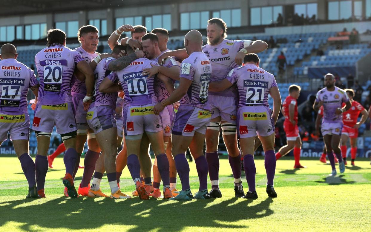 Joe Simmonds of Exeter Chiefs is mobbed by team mates after scoring against Toulouse  - GETTY IMAGES