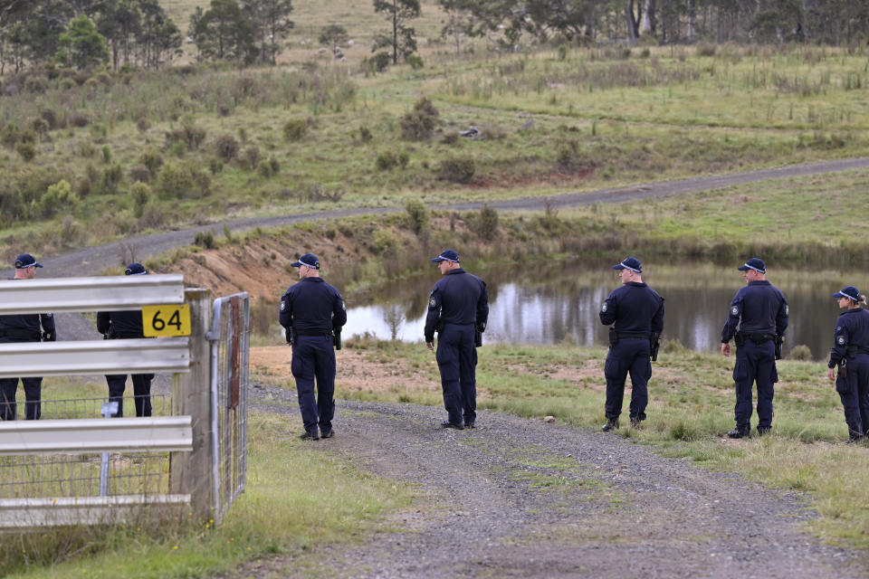 Police conduct a line search near a body of water on a rural property near Bungonia, 170 kilometers (105 miles) southwest of Sydney, Monday, Feb. 26, 2024. Police divers were searching inland waterways on Monday for the bodies of a same-sex couple allegedly shot dead in Sydney a week earlier by a jilted police officer lover with his service pistol.(Mick Tsikas/AAP Image via AP)