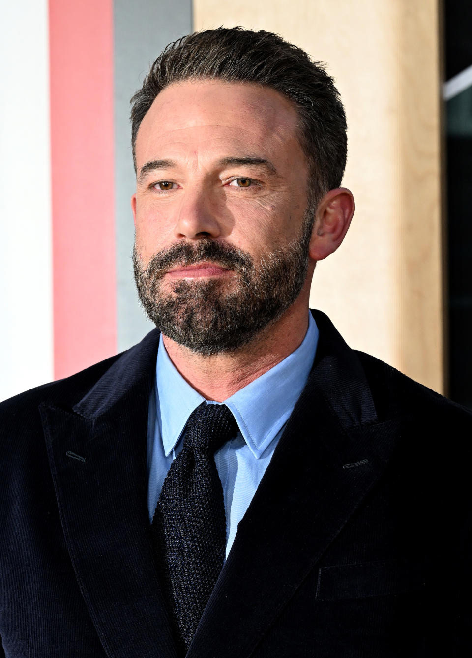 Close-up of Ben in a suit and tie at a media event