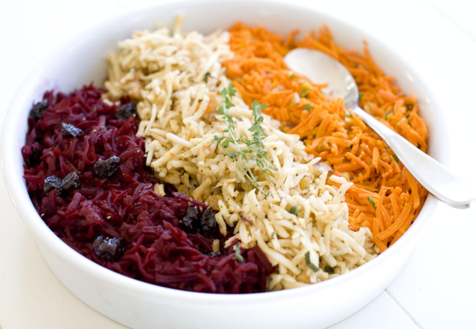 This Nov. 18, 2013 photo shows, from left, shredded beets with balsamic, shredded parsnips with walnuts, and shredded spicy carrots, in Concord, N.H. (AP Photo/Matthew Mead)