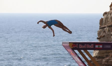 A diver jumps off a cliff during the Red Bull Cliff Diving World Series at the Raouche rock in Beirut