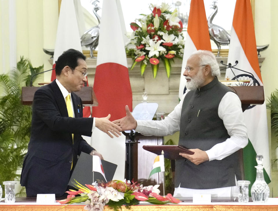 Indian Prime Minister Narendra Modi shakes hand with his Japanese counterpart Fumio Kishida during a signing of agreements in New Delhi, Saturday, March 19, 2022. Kishida Saturday said his country will invest $42 billion in India over the next five years in a deal that is expected to boost bilateral trade between New Delhi and Tokyo. (AP Photo/Manish Swarup)