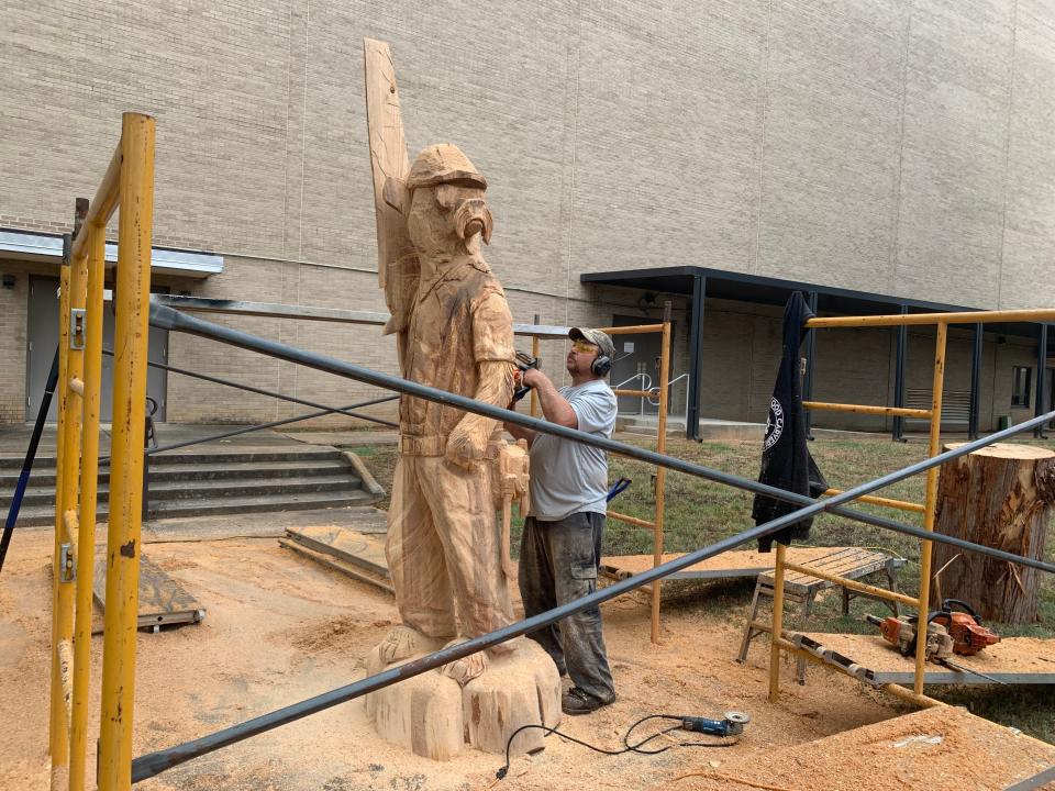 Dayton Scoggins carves a bear statue in Jackson on Oct. 12 for the 2023 Great Delta Bear Affair later that month.
