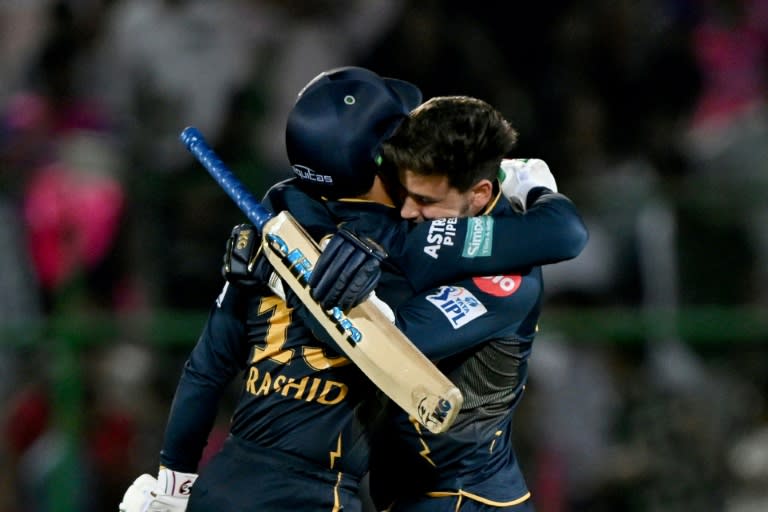 Gujarat Titans' Rashid Khan (L) and Noor Ahmad celebrate after their win against Rajasthan Royals (Arun SANKAR)