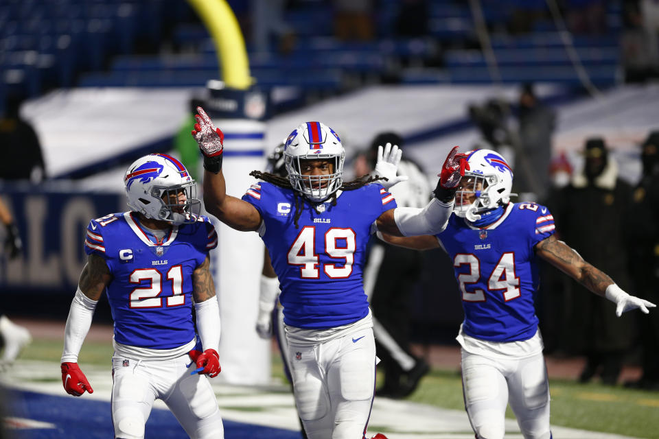 Buffalo Bills middle linebacker Tremaine Edmunds (49) celebrates with Jordan Poyer (21) and Taron Johnson (24) during the second half of an NFL divisional round football game Saturday, Jan. 16, 2021, in Orchard Park, N.Y. The Bills won 17-3. (AP Photo/John Munson)