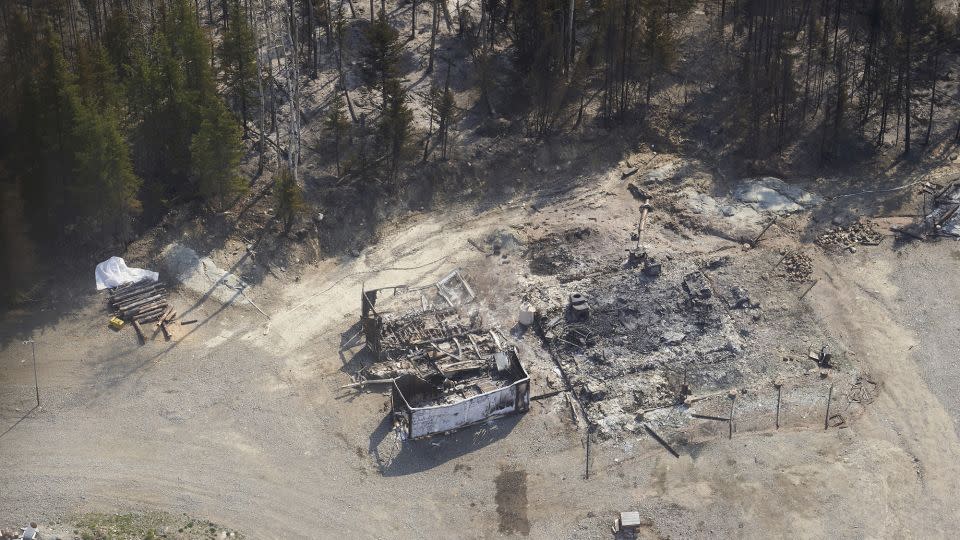 A cottage destroyed by wildfires burning in northern Manitoba, Canada, as seen from a helicopter on Tuesday, May 14, 2024. - David Lipnowski/The Canadian Press/AP