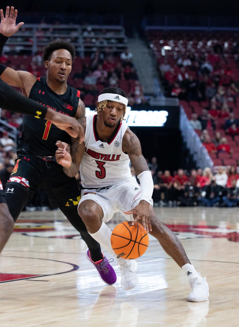 U of L’s El Ellis (3) drives againstt Maryland’s Jahmir Young (1) during their game at the Yum Center in Louisville, Ky. on Nov. 29, 2022.  