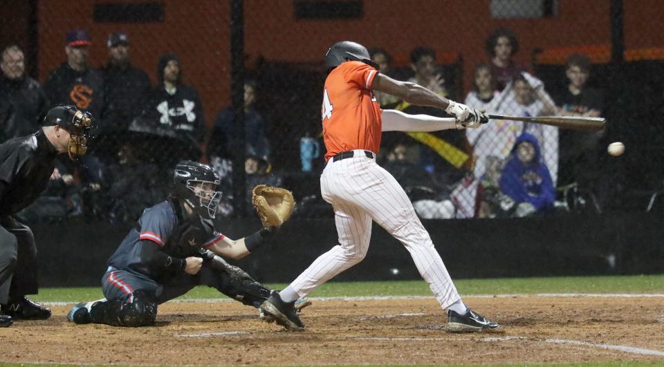 Spruce Creek's Lamar Edwards (14) rips a double to right field against Seabreeze, Thursday, Feb. 29, 2024 at Spruce Creek High School.