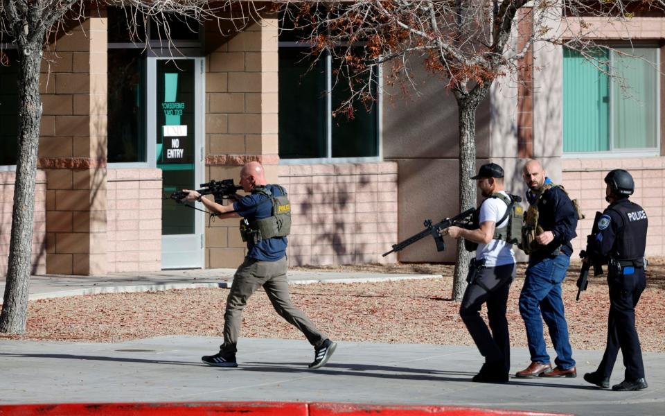 Armed police rush into a building on the university's campus