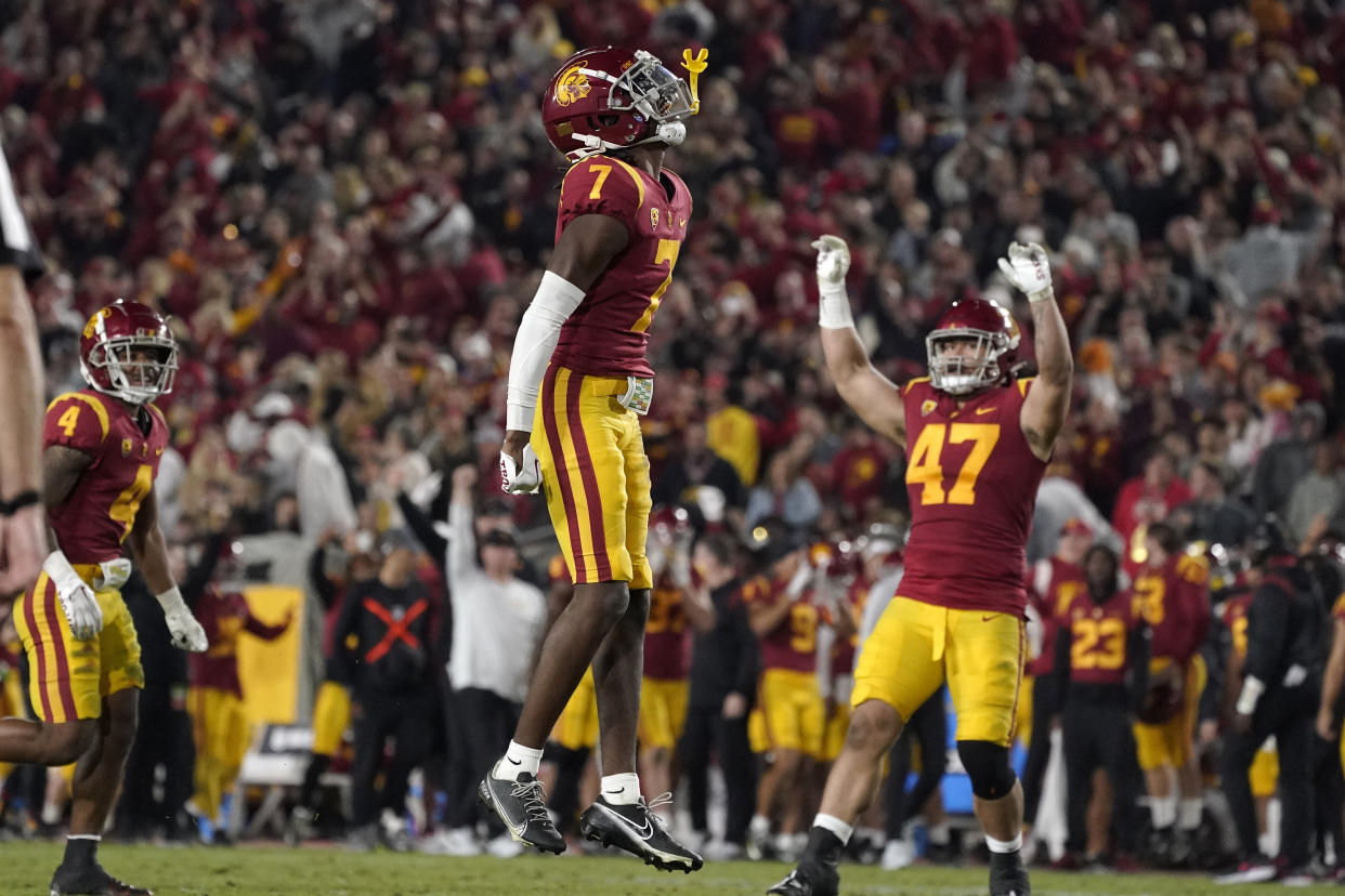 USC defensive back Calen Bullock (7) celebrates along with defensive lineman Stanley Ta'ufo'ou, right, after intercepting a pass during the second half of an NCAA college football game against Notre Dame Saturday, Nov. 26, 2022, in Los Angeles. (AP Photo/Mark J. Terrill)