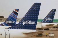 JetBlue Airways aircraft are pictured at departure gates at John F. Kennedy International Airport in New York June 15, 2013. REUTERS/Fred Prouser