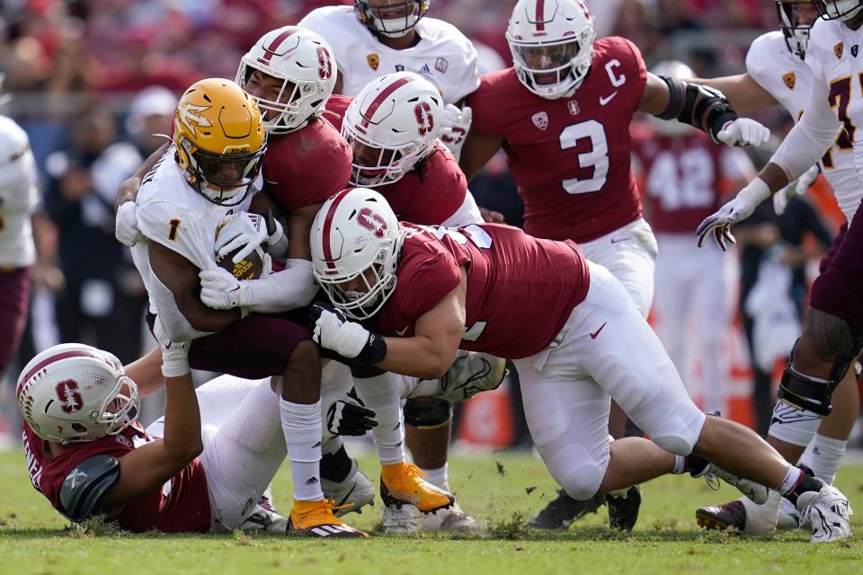 Arizona State running back Xazavian Valladay (1) is tackled by Stanford defenders during the first half of an NCAA college football game in Stanford, Calif., Saturday, Oct. 22, 2022.