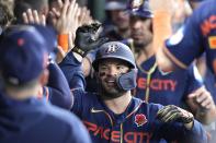 Houston Astros' Jose Altuve celebrates in the dugout after hitting a grand slam against the Minnesota Twins during the seventh inning of a baseball game Monday, May 29, 2023, in Houston. (AP Photo/David J. Phillip)