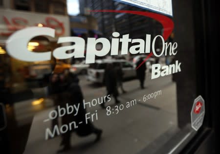 People walk past a Capital One banking center in New York's financial district