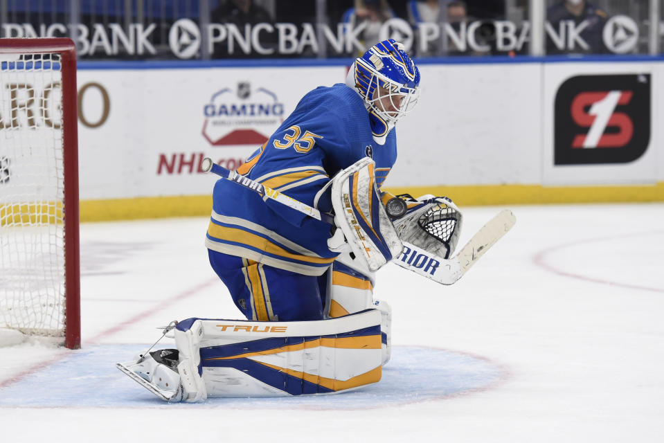 St. Louis Blues' Ville Husso (35) blocks a shot from the Minnesota Wild during the third period of an NHL hockey game on Saturday, April 10, 2021, in St. Louis. (AP Photo/Joe Puetz)
