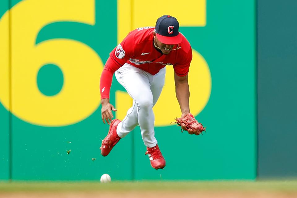 Guardians outfielder Richie Palacios cannot make a catch on a single by Cincinnati Reds outfielder Tyler Naquin during the eighth inning of the Reds' 4-2 win Thursday in Cleveland. [Ron Schwane/Associated Press]