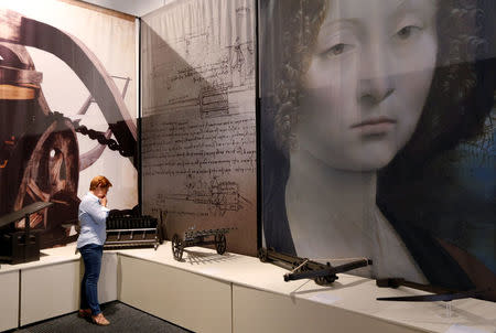 A woman watches reproductions of weapons designed by 15th century inventor Leonardo da Vinci during the exhibition "Leonardo da Vinci, the inventions of a Genius" in Bruges, Belgium May 30, 2017. REUTERS/Francois Lenoir