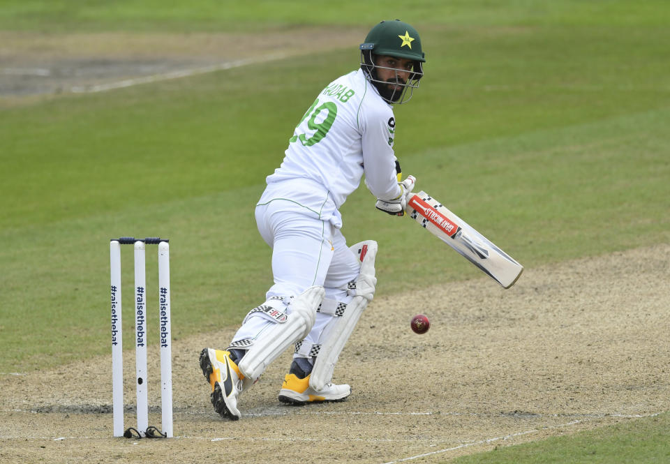 Pakistan's Shadab Khan watches the ball after playing a shot during the second day of the first cricket Test match between England and Pakistan at Old Trafford in Manchester, England, Thursday, Aug. 6, 2020. (Dan Mullan/Pool via AP)