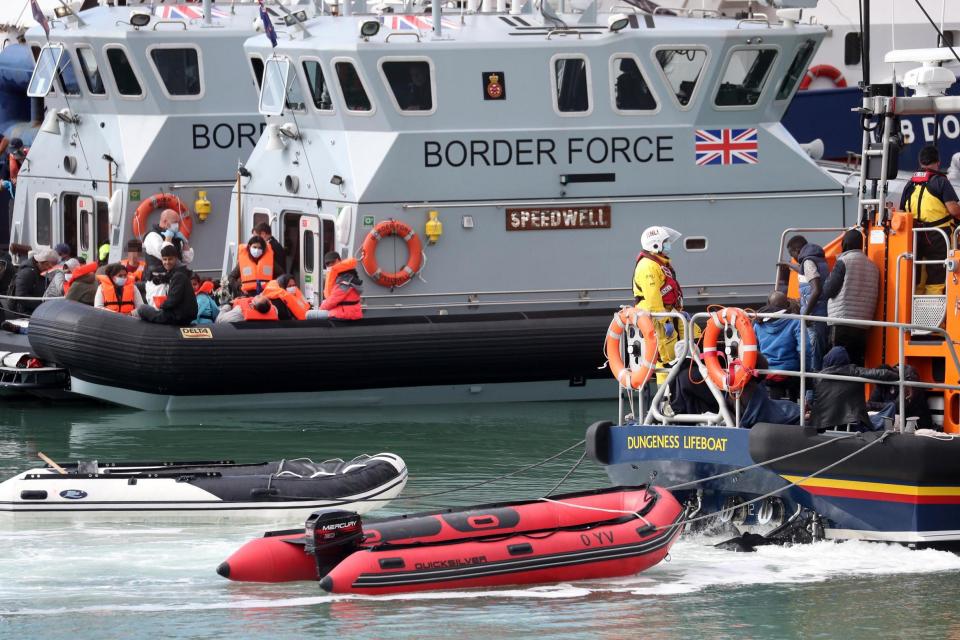 Migrants being helped ashore at Dover (PA)