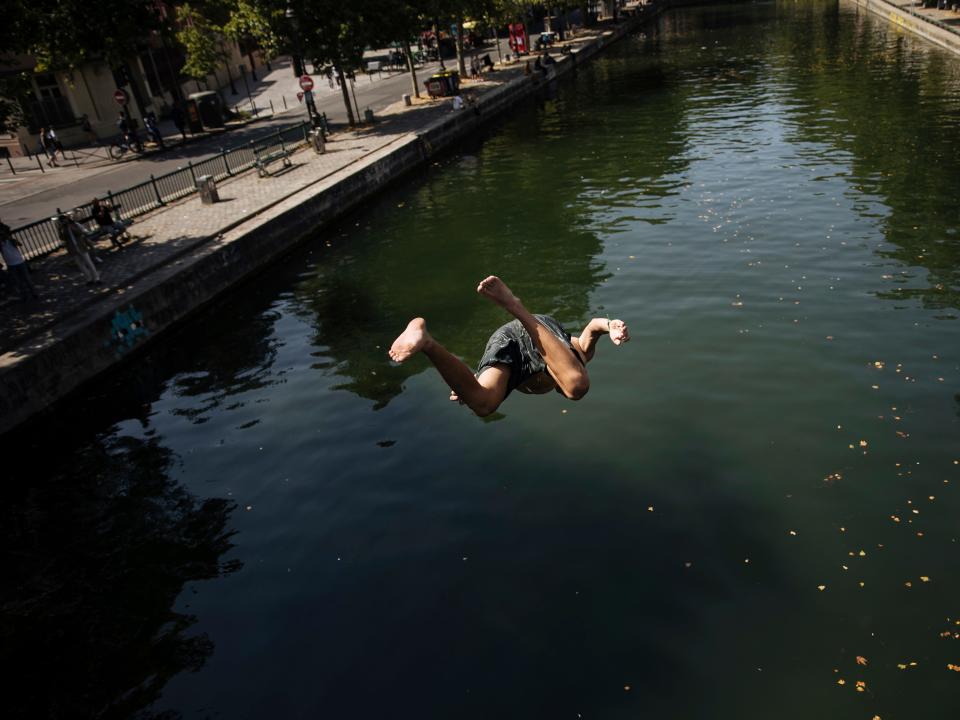 A child dives headfirst into the Canal St. Martin in Paris.