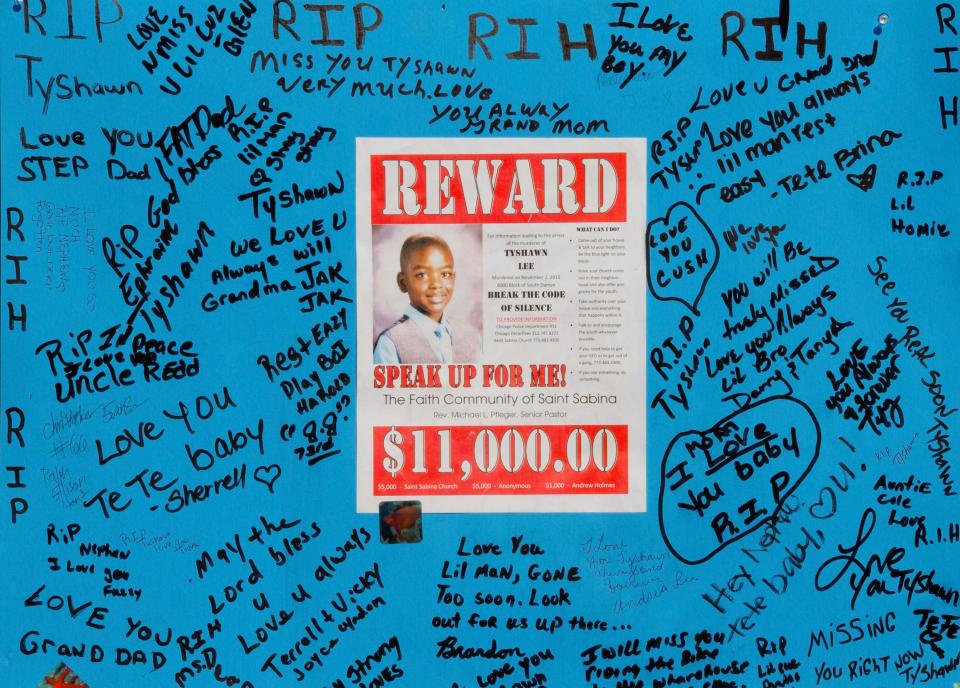A reward sign and messages hang near the site where Tyshawn Lee was fatally shot in Chicago, on Nov. 4, 2015.