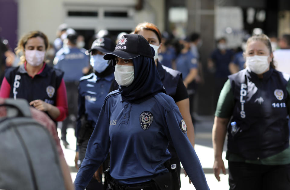 Police officers wearing masks to help protect against the spread of coronavirus, follow protesters, in Ankara, Turkey, Tuesday, June 29, 2021. Turkey's Health Minister Fahrettin Koca has announced Wednesday that a third jab would be available for health-care workers and people above the age of 50.( Photo/Burhan Ozbilici)