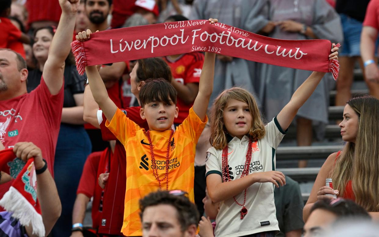 Liverpool fans cheer on the players