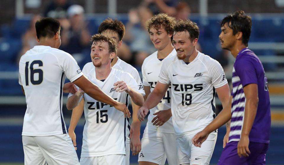 Akron midfielder Johnny Fitzgerald, left facing, celebrates with Wan Kuzri Wan Kamal after scoring during the first half against Niagara Thursday in Akron.