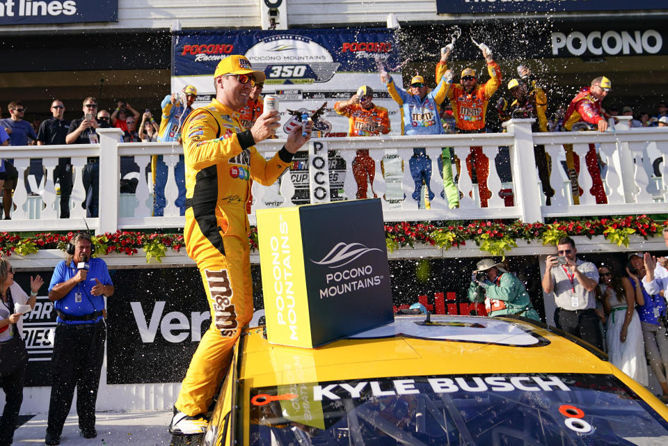 Kyle Busch celebrates with teammates after winning a NASCAR Cup Series auto race at Pocono Raceway, Sunday, June 27, 2021, in Long Pond, Pa. (AP Photo/Matt Slocum)