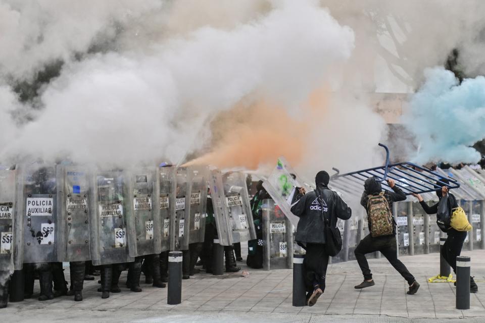 Protesters clash with the local police during a demonstration to commemorate the International Women's Day in Mexico City, on March 8, 2021. (Photo by PEDRO PARDO / AFP) (Photo by PEDRO PARDO/AFP via Getty Images)