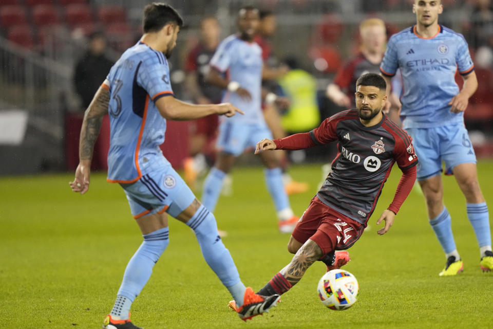 Toronto FC forward Lorenzo Insigne (24) moves toward the ball in front of New York City FC defender Thiago Martins (13) during the second half of an MLS soccer match Saturday, May 11, 2024, in Toronto. (Frank Gunn/The Canadian Press via AP)