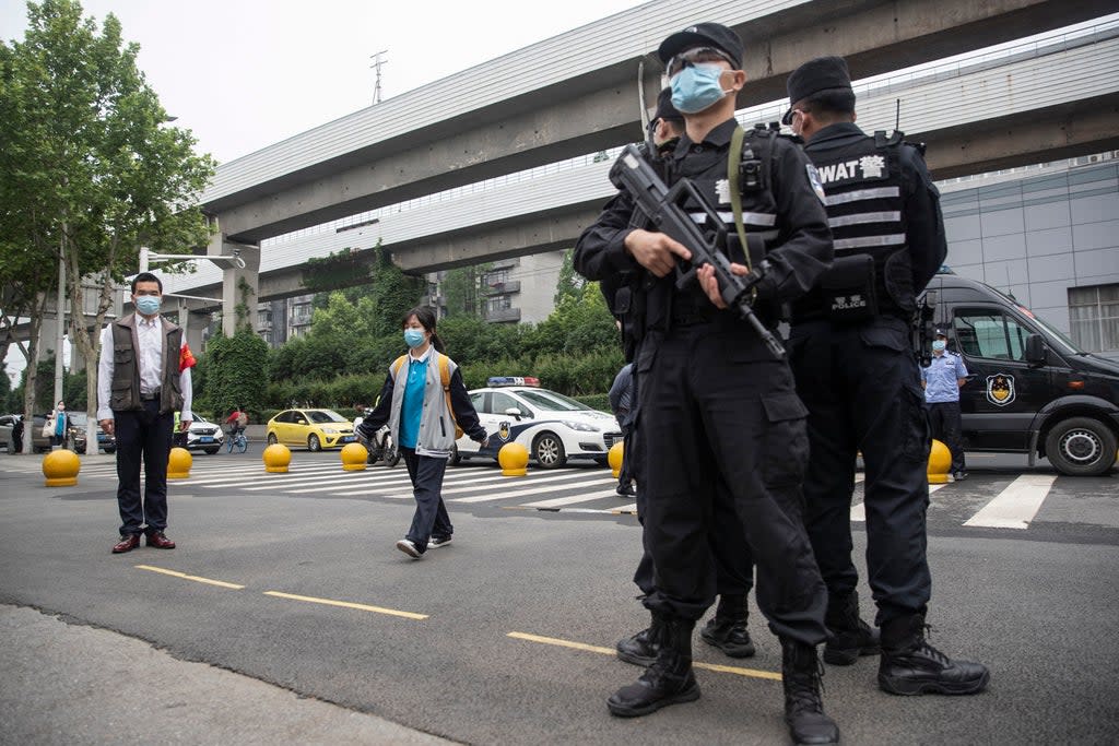 File Image: Police standing outside a school in Wuhan, China on 6 May 2020 (AFP via Getty Images)