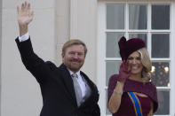 FILE - In this Tuesday, Sept. 17, 2019 file photo, Dutch King Willem-Alexander and Queen Maxima wave from the balcony of royal palace Noordeinde in The Hague, Netherlands. As the British royal family wrestles with the future roles of Prince Harry and his wife Meghan, it could look to Europe for examples of how princes and princesses have tried to carve out careers away from the pomp and ceremony of their families’ traditional duties. King Willem-Alexander has a full-time job as his country’s monarch but he still finds time to fly KLM passenger jets to rack up enough hours in the cockpit to keep his pilot’s license. (AP Photo/Peter Dejong, File)